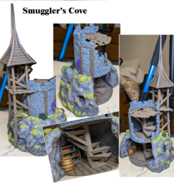 A painted 3D print of the Smuggler's Cove terrain, featuring a ruined gray stone tower built upon a mossy rock cliff. A wooden scaffolding and a pointed wooden roof adorn the tower. A hidden cave in the cliff reveals a detailed interior with wooden stairs, shelves of bottles, and a barrel.