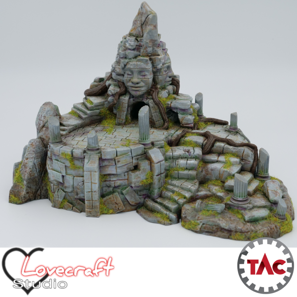 3D printed and painted model of an ancient jungle shrine with a large carved stone face, crumbling stairs, broken pillars, and thick overgrown roots.