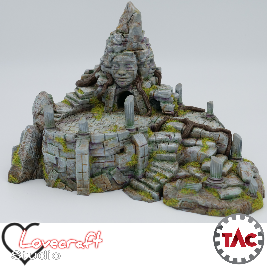 3D printed and painted model of an ancient jungle shrine with a large carved stone face, crumbling stairs, broken pillars, and thick overgrown roots.