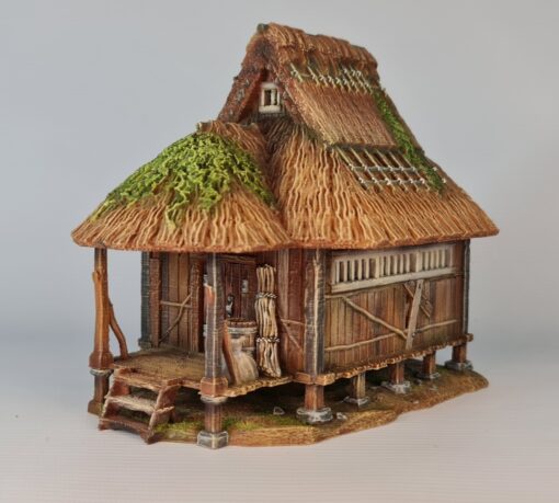 A 28mm scale 3D printed model of a traditional Japanese Gassho-style farmhouse (Minka) featuring a steep, highly textured thatched roof, raised wooden porch, and timber-framed walls on a stone foundation.