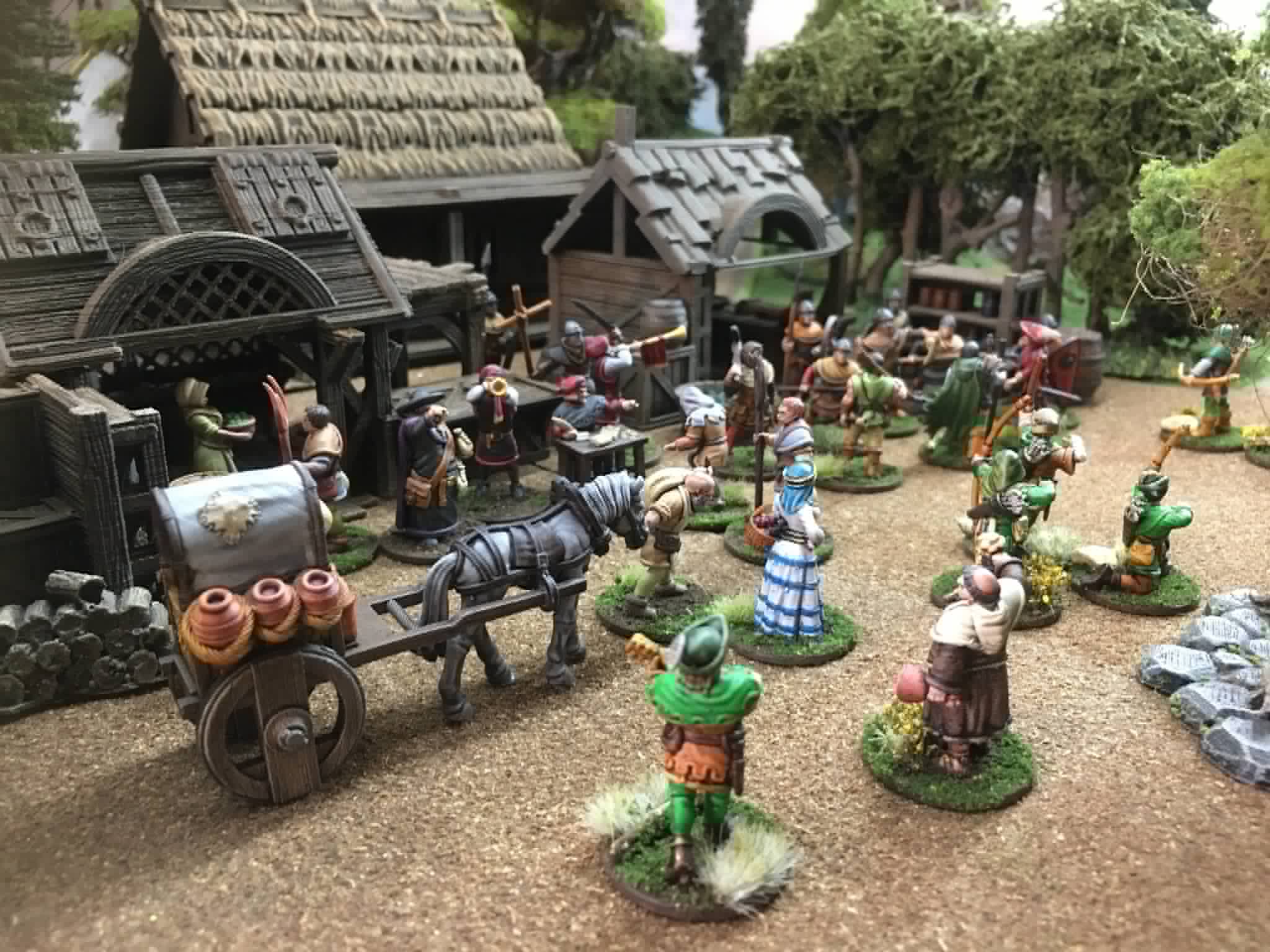 Iain Lovecraft Robin Hood 3D printable miniatures set in a detailed medieval village diorama, as featured in Miniature Wargames magazine